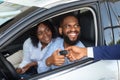 Happy African American Couple Taking Key From Salesman After Buying New Car Royalty Free Stock Photo