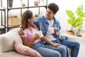 Happy african american couple drinking coffee at cozy home