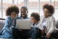 Happy African American couple and two kids relaxing on couch Royalty Free Stock Photo