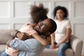 Happy african american dad embracing daughter cuddling at home Royalty Free Stock Photo