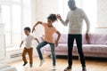 Happy african American dad have fun dancing with kids Royalty Free Stock Photo