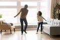 Happy african dad and kid daughter dancing in living room Royalty Free Stock Photo