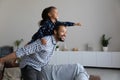 Happy African American dad piggybacking excited proud daughter kid