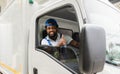 Happy African American delivery service man driver in uniform sitting smiling and thumb up with looking on camera cheerful in a Royalty Free Stock Photo