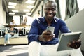 Happy african american entrepreneur using tablet computer. Royalty Free Stock Photo