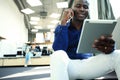 Happy african american entrepreneur using tablet computer. Royalty Free Stock Photo