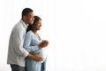 Happy african american expecting family looking at copy space Royalty Free Stock Photo