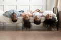 Happy african american family bonding lying upside down on bed Royalty Free Stock Photo