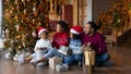 Happy African American family celebrating Christmas, holding gifts Royalty Free Stock Photo