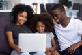 Happy african family with child having fun using laptop together Royalty Free Stock Photo