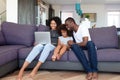 Happy African American family with daughter using laptop at home Royalty Free Stock Photo