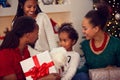 African American family exchanging Christmas gifts