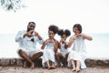 Happy African American family, Father, Mother, Two daughter enjoying and funning together in outdoor park seaside. Vacation relax Royalty Free Stock Photo