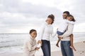 Happy African-American family of four on beach