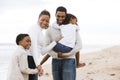 Happy African-American family of four on beach