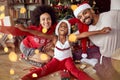 Happy African American family in front of Christmas tree