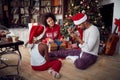 Happy African American family with girl and Christmas gifts on floor at home Royalty Free Stock Photo