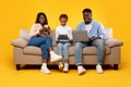 Happy African American family holding and using gadgets Royalty Free Stock Photo