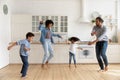 Happy African American family with kids dancing in kitchen together Royalty Free Stock Photo