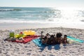 Happy african american family lying together at beach enjoying summer holiday together Royalty Free Stock Photo