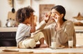 Happy african american family: mother and little son eat cookies with milk at home