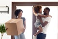 Happy African American family moving in new own house