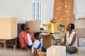 Happy african american family playing in new house with box filling material Royalty Free Stock Photo