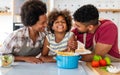 Happy african american family preparing healthy food in kitchen, having fun together on weekend Royalty Free Stock Photo