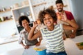 Happy african american family preparing healthy food in kitchen, having fun together on weekend Royalty Free Stock Photo