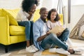 happy african american family reading book together