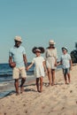 happy african american family with rugby ball walking together