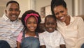 Happy African American family sitting on the sofa and looking at camera Royalty Free Stock Photo