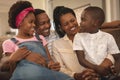 Happy African American family sitting on the sofa and looking each other Royalty Free Stock Photo