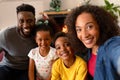 Happy african american family sitting on sofa, taking selfie Royalty Free Stock Photo