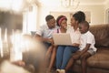 Happy African American family sitting on the sofa and using laptop Royalty Free Stock Photo