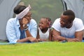 Happy African American family spending time together during vacation on the camping tent outdoor park Royalty Free Stock Photo