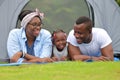 Happy African American family spending time together during vacation on the camping tent outdoor park Royalty Free Stock Photo