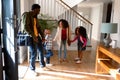 Happy african american family standing in hallway, returning back home Royalty Free Stock Photo
