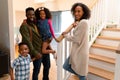 Happy african american family standing at stairs and looking at camera Royalty Free Stock Photo