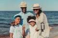 happy african american family with two kids taking selfie with smartphone at seaside Royalty Free Stock Photo