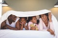 Happy African American family under blanket and looking each other Royalty Free Stock Photo