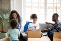 Happy African American family unpacking boxes, just moving