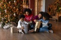 Happy African American family unpacking gifts on Christmas eve Royalty Free Stock Photo
