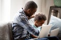 Happy African American family using laptop together at home Royalty Free Stock Photo