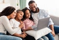 Happy african american family using laptop in living room Royalty Free Stock Photo