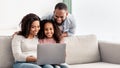 Happy african american family using laptop in living room Royalty Free Stock Photo