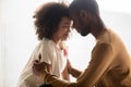 Loving African American father and daughter hugging, touching foreheads Royalty Free Stock Photo