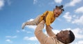 Happy african american father with baby over sky Royalty Free Stock Photo