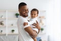 Happy African American Father Cuddling His Adorable Newborn Baby Son At Home Royalty Free Stock Photo