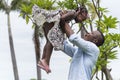 Happy african american Father & Daughter child girl play throws airplane enjoying active with outside house background Royalty Free Stock Photo